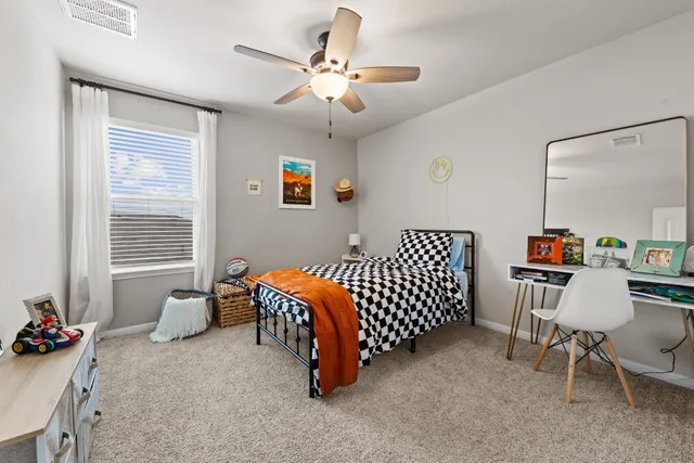 a bedroom with furniture and a window