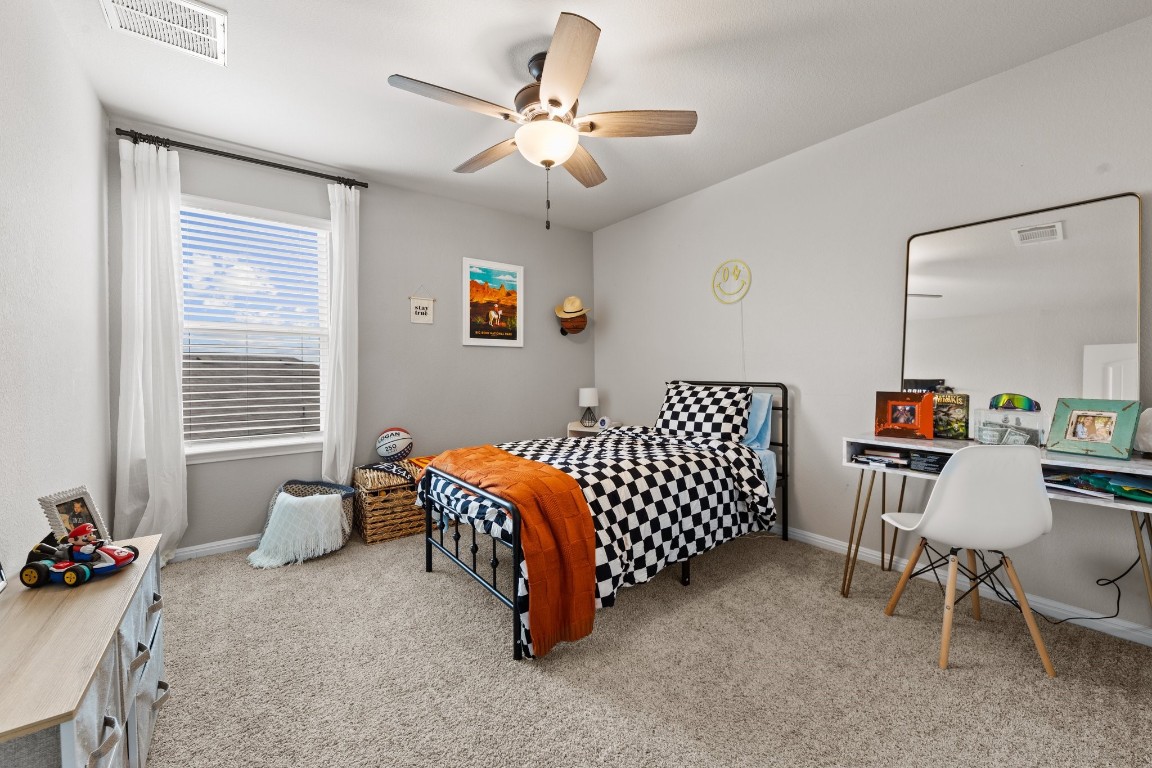 104 Blue Sage Drive Leander, TX 78641 - Photo 6 of 12 a bedroom with furniture and a window