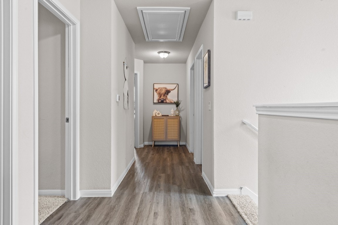 104 Blue Sage Drive Leander, TX 78641 - Photo 9 of 12 a view of a hallway with wooden floor