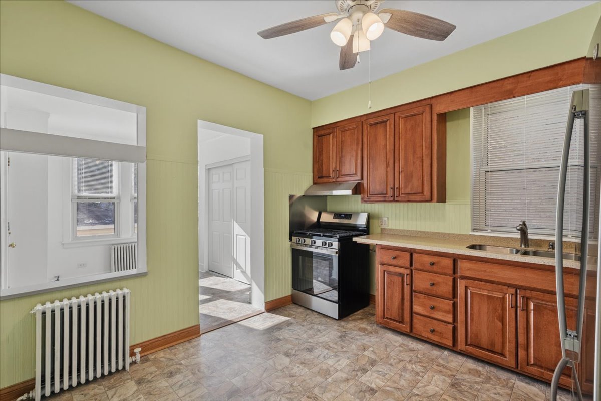 5033 West Cullom Avenue, Unit 1 Chicago, IL 60641 - Photo 11 of 20 a kitchen with stainless steel appliances granite countertop a sink stove and refrigerator