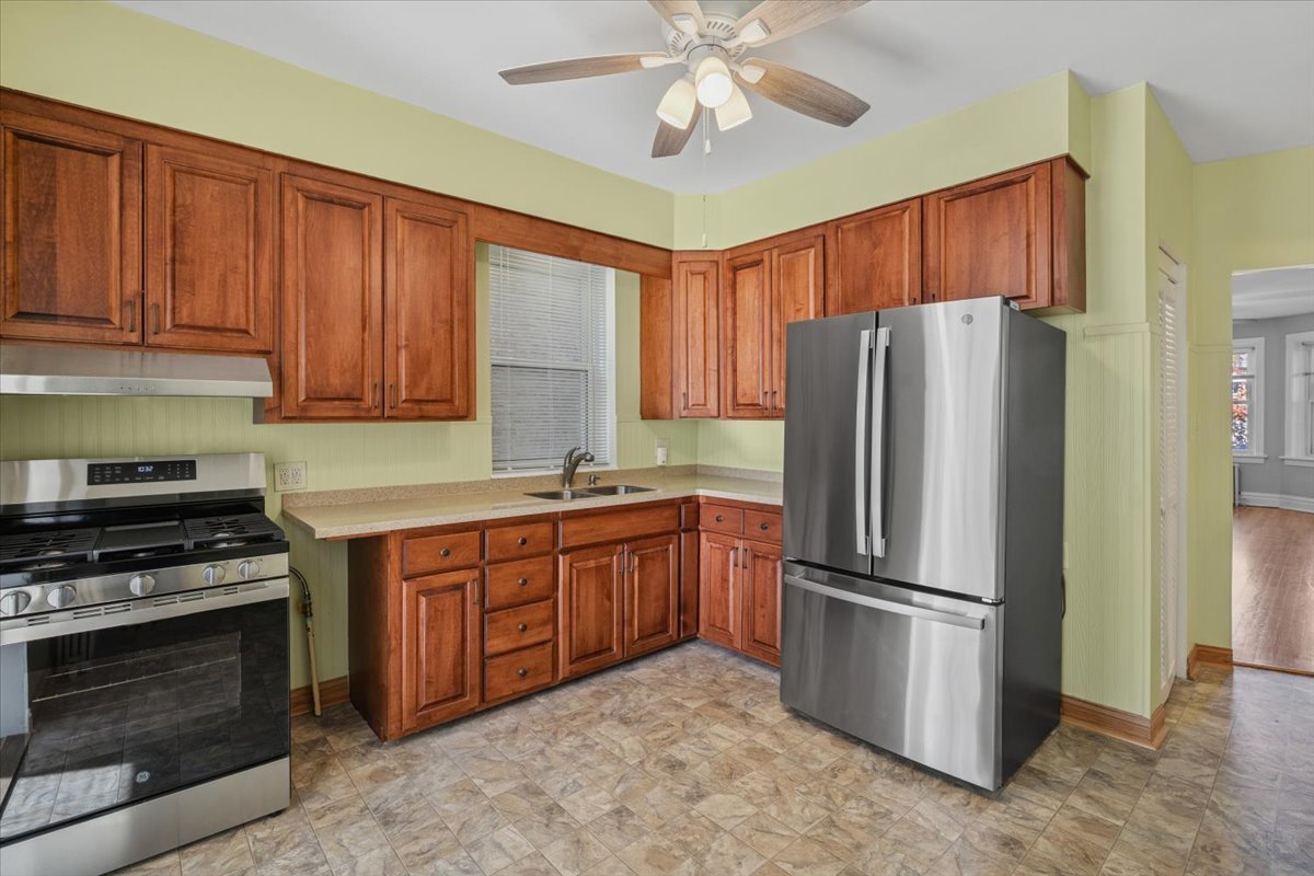 5033 West Cullom Avenue, Unit 1 Chicago, IL 60641 - Photo 12 of 20 a kitchen with stainless steel appliances granite countertop a refrigerator stove and sink