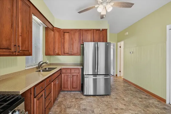 a kitchen with stainless steel appliances granite countertop a refrigerator sink and cabinets