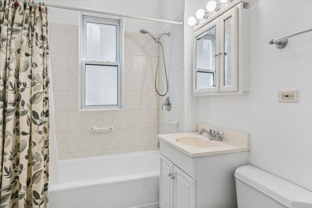 5033 West Cullom Avenue, Unit 1 Chicago, IL 60641 - Photo 15 of 20 a bathroom with a sink toilet and shower