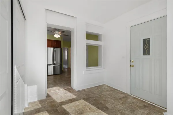 a view of a backyard with table and chairs with wooden fence and plants