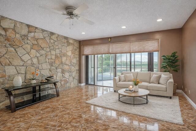 7512 Ace Road North Lake Worth, FL 33467 - Photo 12 of 25 a living room with furniture and a large window
