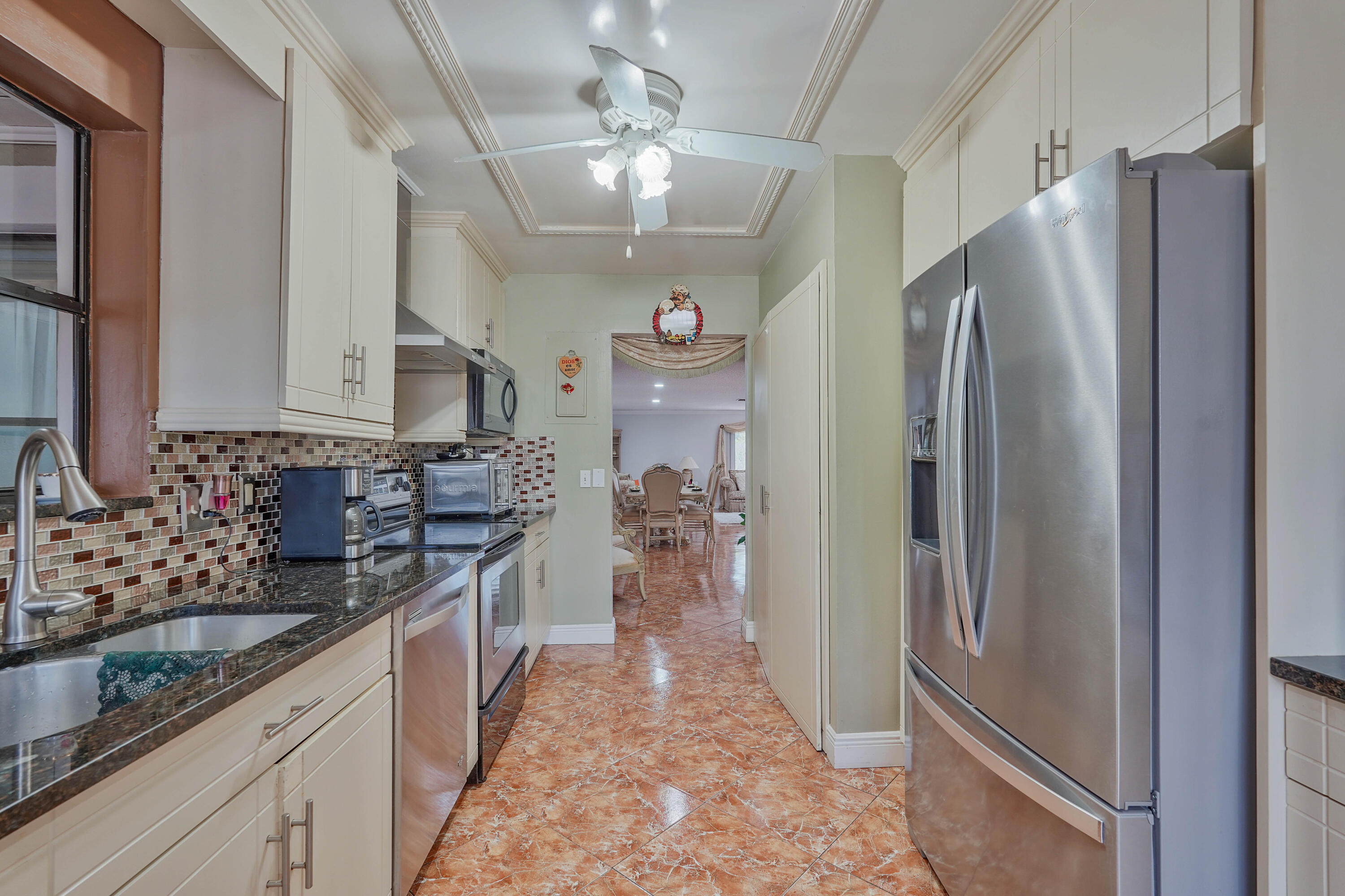 7512 Ace Road North Lake Worth, FL 33467 - Photo 4 of 25 a kitchen with stainless steel appliances granite countertop a refrigerator and a sink