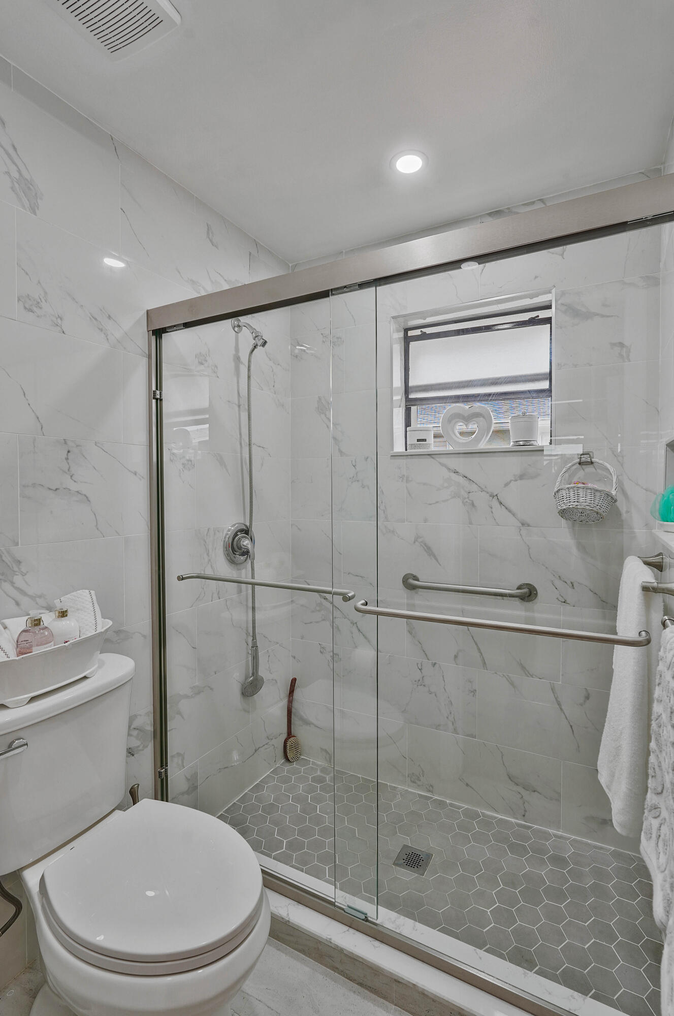 7512 Ace Road North Lake Worth, FL 33467 - Photo 9 of 25 a white toilet next to a bathroom sink