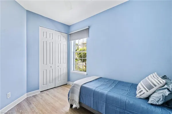 a bedroom with a bed and a lamp
