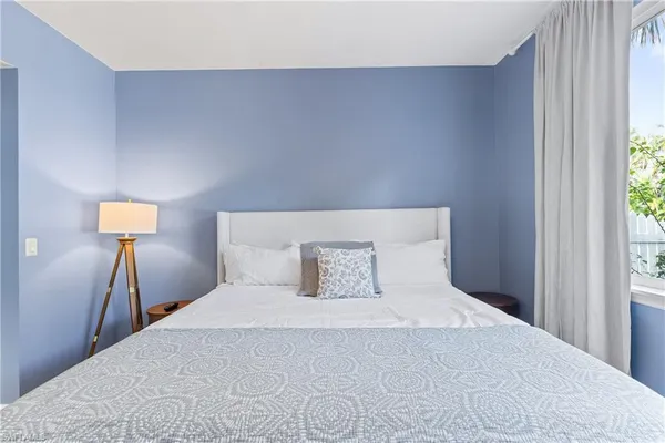 a bedroom with a bed and window