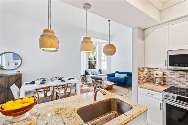 a dining room with furniture and a window
