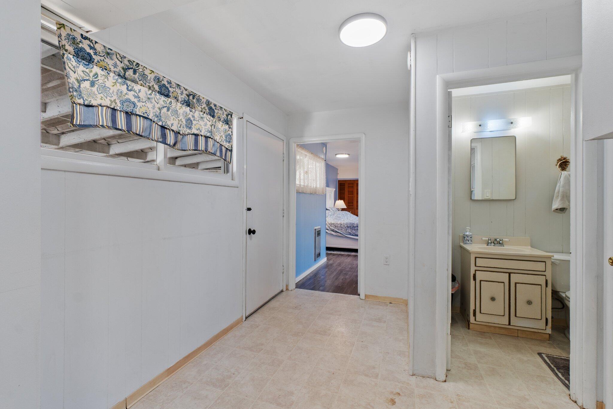 686 Coronado Street Redding, CA 96003 - Photo 16 of 39 a view of a hallway and a bathroom with sink