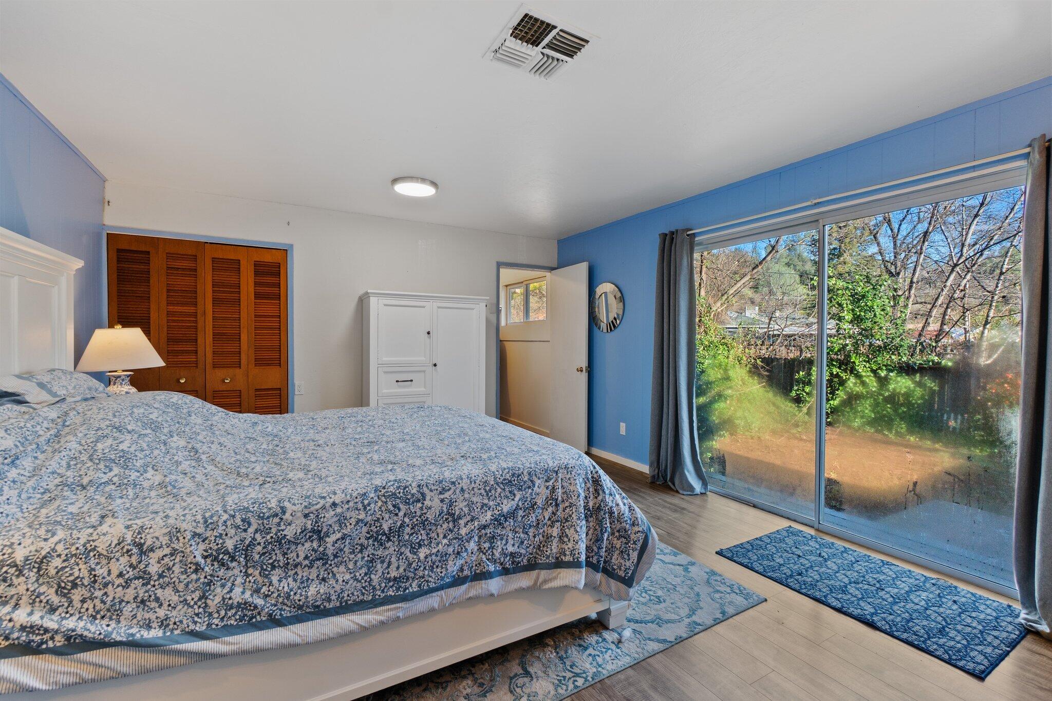 686 Coronado Street Redding, CA 96003 - Photo 23 of 39 a bedroom with a large bed and large window