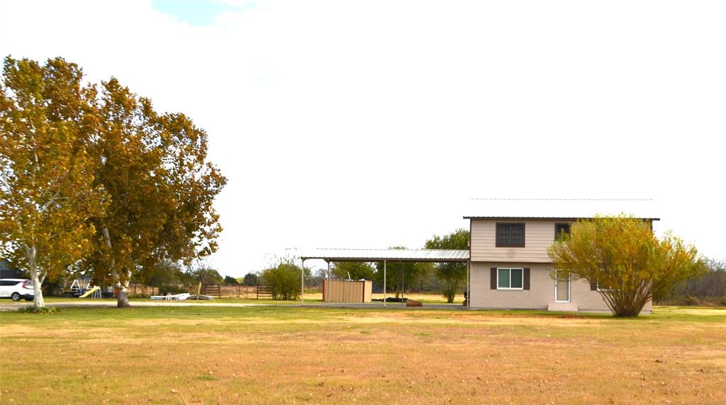 a front view of residential houses with yard and lake view