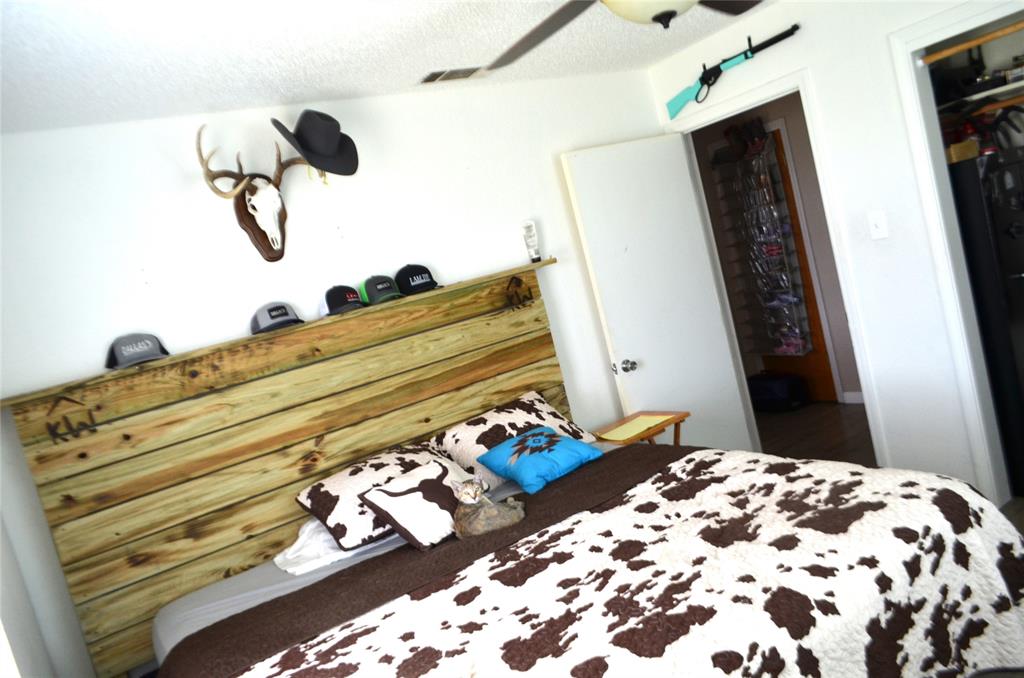 7331 Taylor Ranch Loop Kaufman, TX 75142 - Photo 16 of 34 a bedroom with a bed and wooden floor