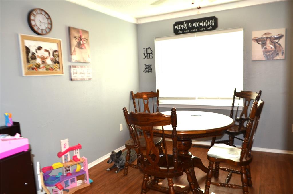 7331 Taylor Ranch Loop Kaufman, TX 75142 - Photo 22 of 34 a view of a dining room with furniture and wooden floor