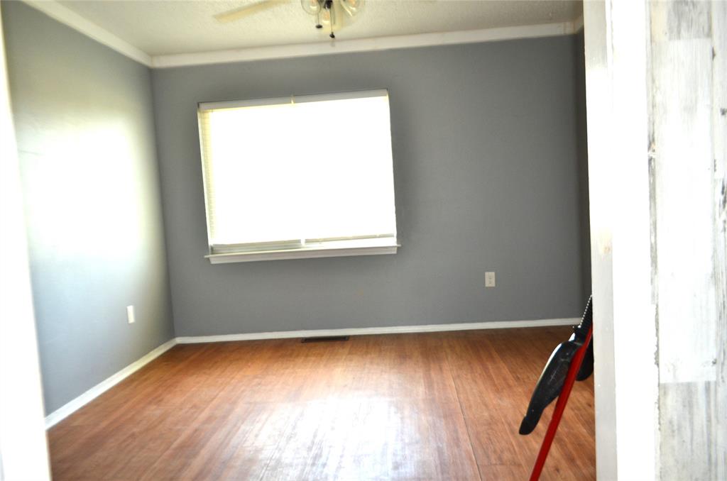 7331 Taylor Ranch Loop Kaufman, TX 75142 - Photo 24 of 34 a view of an empty room with wooden floor and a window