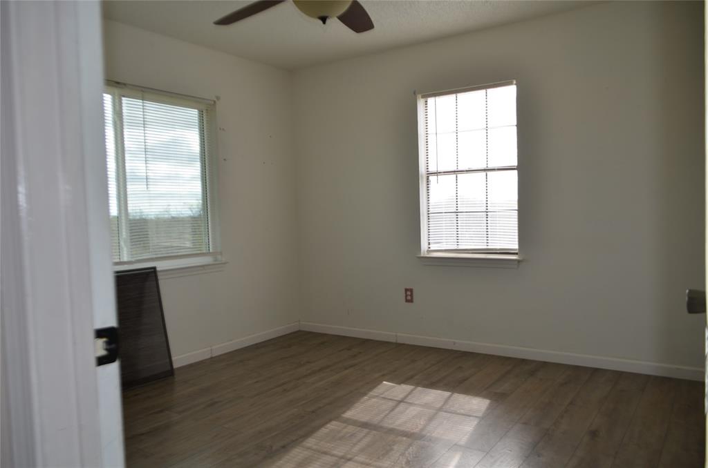 7331 Taylor Ranch Loop Kaufman, TX 75142 - Photo 27 of 34 an empty room with wooden floor and windows