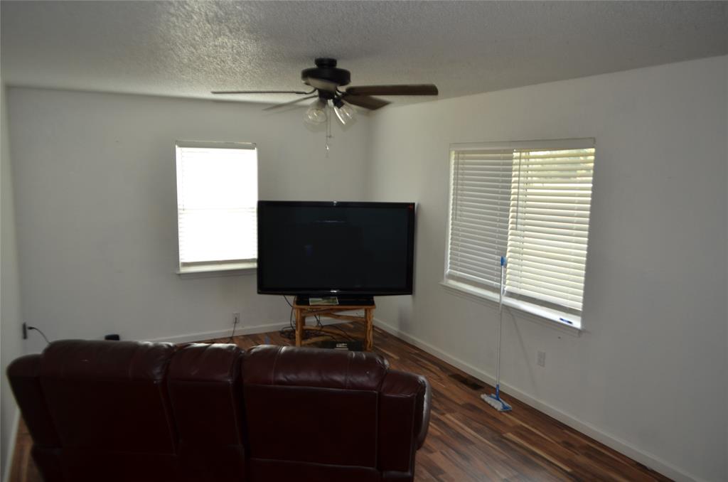 7331 Taylor Ranch Loop Kaufman, TX 75142 - Photo 32 of 34 a living room with furniture and a flat screen tv