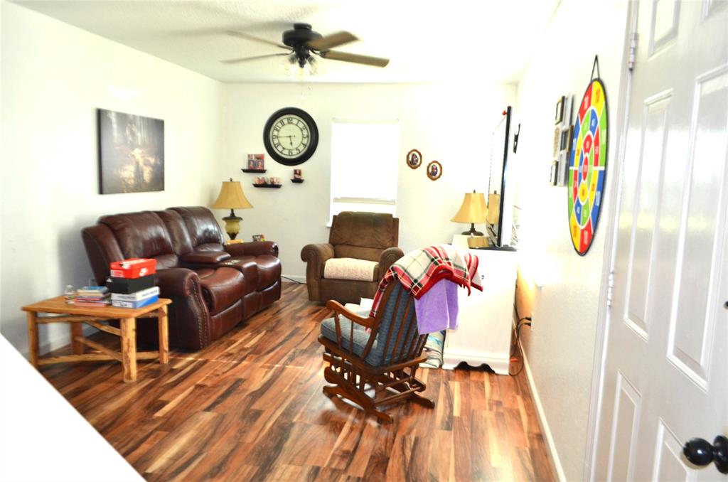 7331 Taylor Ranch Loop Kaufman, TX 75142 - Photo 5 of 34 a living room with furniture and a wooden floor