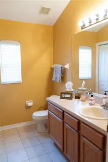 a large bed sitting in a bedroom next to a window