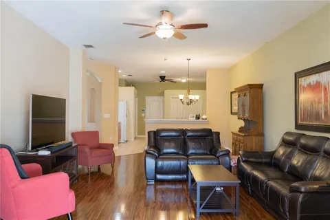 a living room with furniture and wooden floor