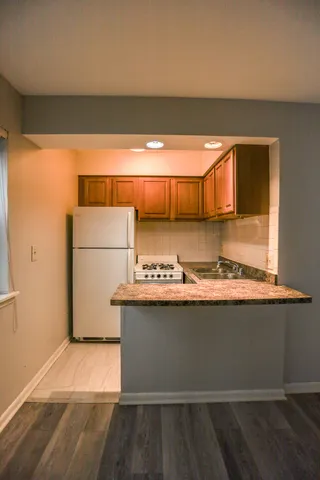 a view of kitchen with a sink and a refrigerator