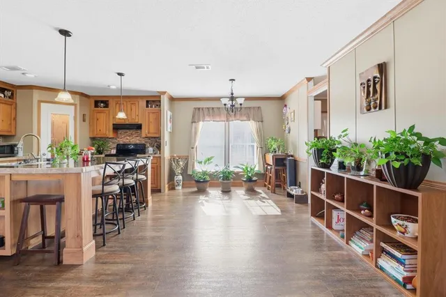 a room with lots of wooden furniture and potted plant