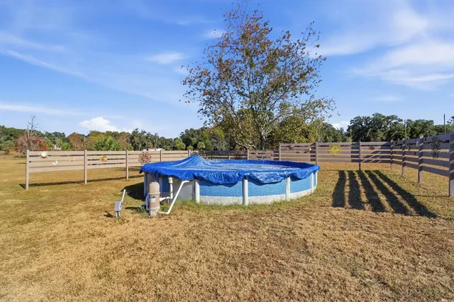 a view of a swimming pool with a lounge chair