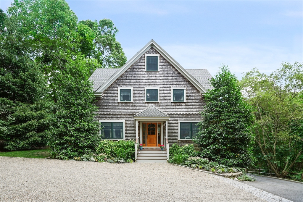 61 Causeway Road Tisbury, MA 02568 - Photo 1 of 42 a front view of a house with a yard and garage