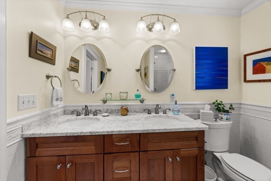 61 Causeway Road Tisbury, MA 02568 - Photo 26 of 42 a bathroom with a double vanity sink and a mirror
