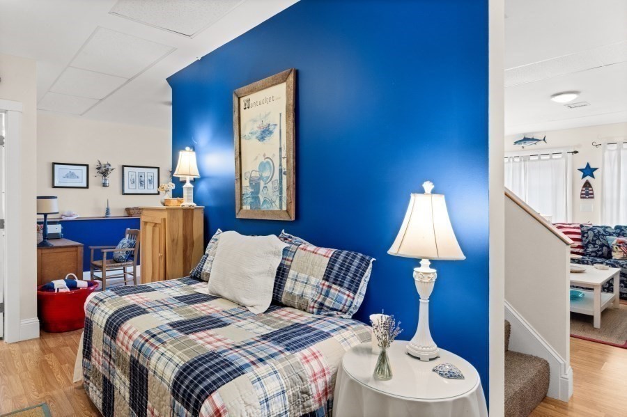 61 Causeway Road Tisbury, MA 02568 - Photo 40 of 42 a bed room with a bed and a lamp
