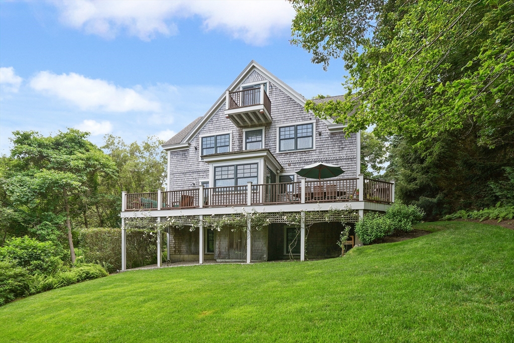 61 Causeway Road Tisbury, MA 02568 - Photo 4 of 42 a view of a big house with a big yard and large trees