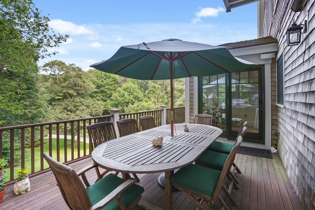 61 Causeway Road Tisbury, MA 02568 - Photo 6 of 42 a view of a balcony with a table and chairs
