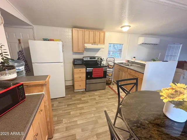 a kitchen with a refrigerator and a stove top oven