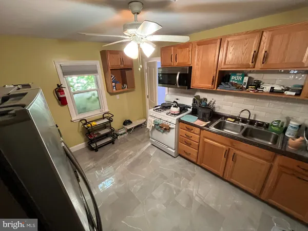 a kitchen with stainless steel appliances granite countertop a sink dishwasher stove and cabinets