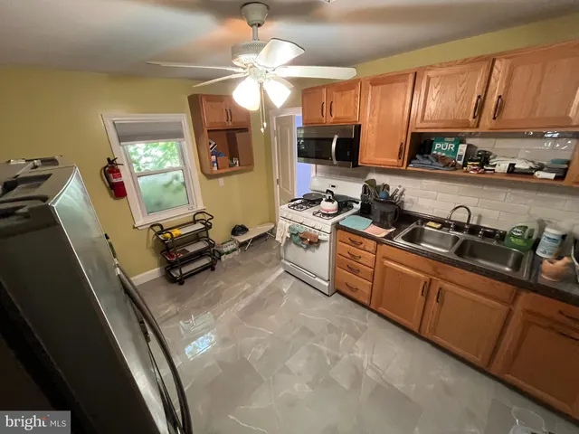 a kitchen with stainless steel appliances granite countertop a sink dishwasher stove and cabinets