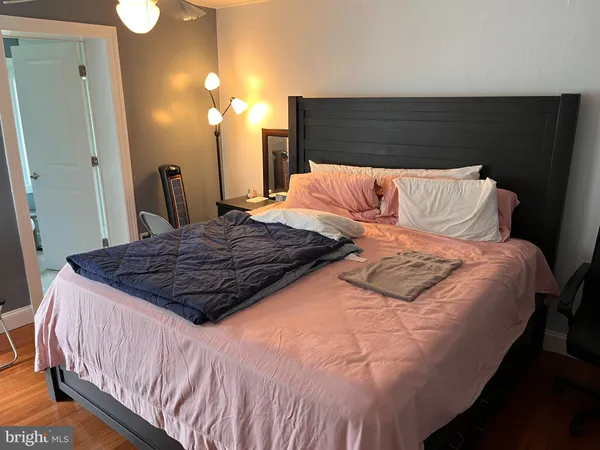 a bedroom with a large bed and a chandelier
