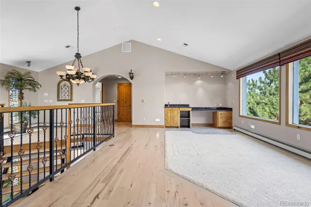 a view of a room with chandelier fan and windows