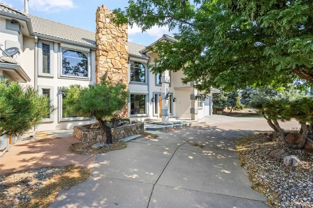 a row of palm trees in front of a building