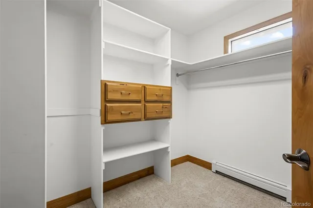 an empty room with a window and a mirror