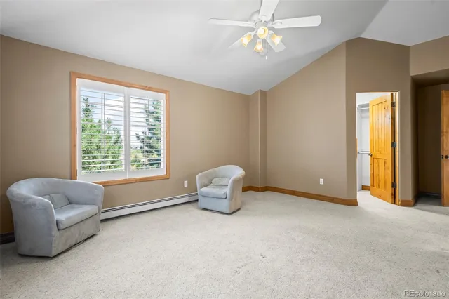 a bathroom with a granite countertop sink a large mirror next to a window