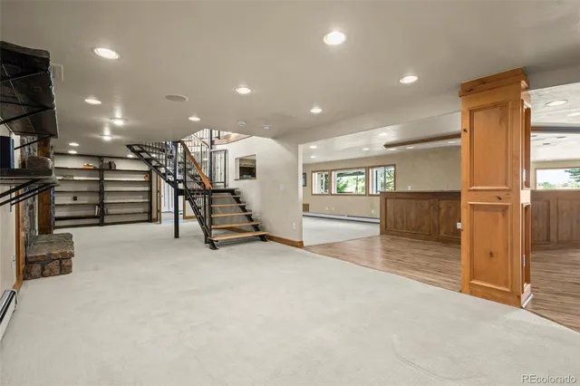 a bathroom with a granite countertop sink a toilet and a mirror