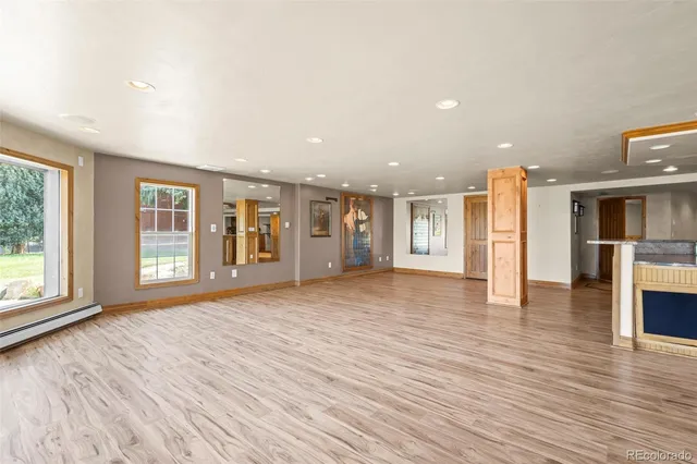 a spacious bathroom with a granite countertop sink a mirror and a shower
