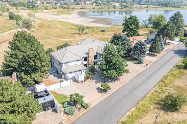 an aerial view of a house with a lake view