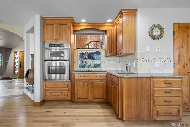 a kitchen with cabinets and wooden floor