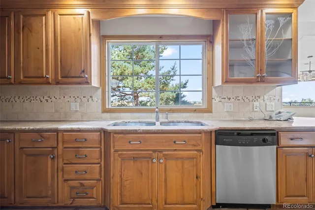 a kitchen with granite countertop white cabinets and a window
