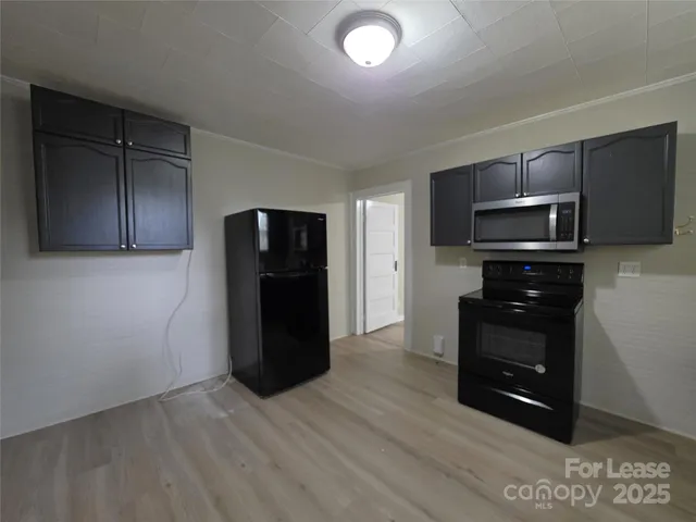 a kitchen with a refrigerator stove and microwave