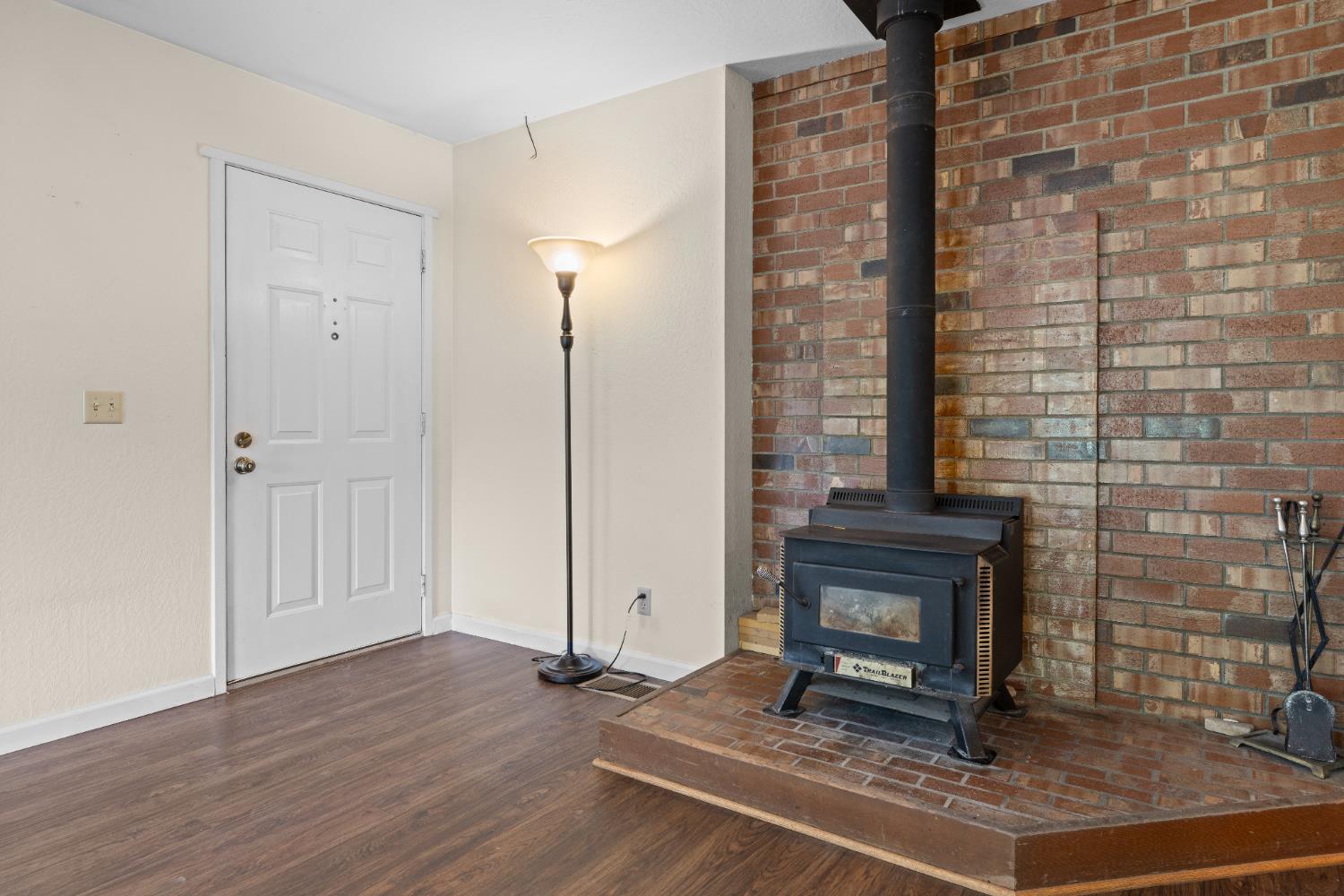 16173 Norlene Way Grass Valley, CA 95949 - Photo 15 of 25 a living room with a fireplace windows and wooden floor