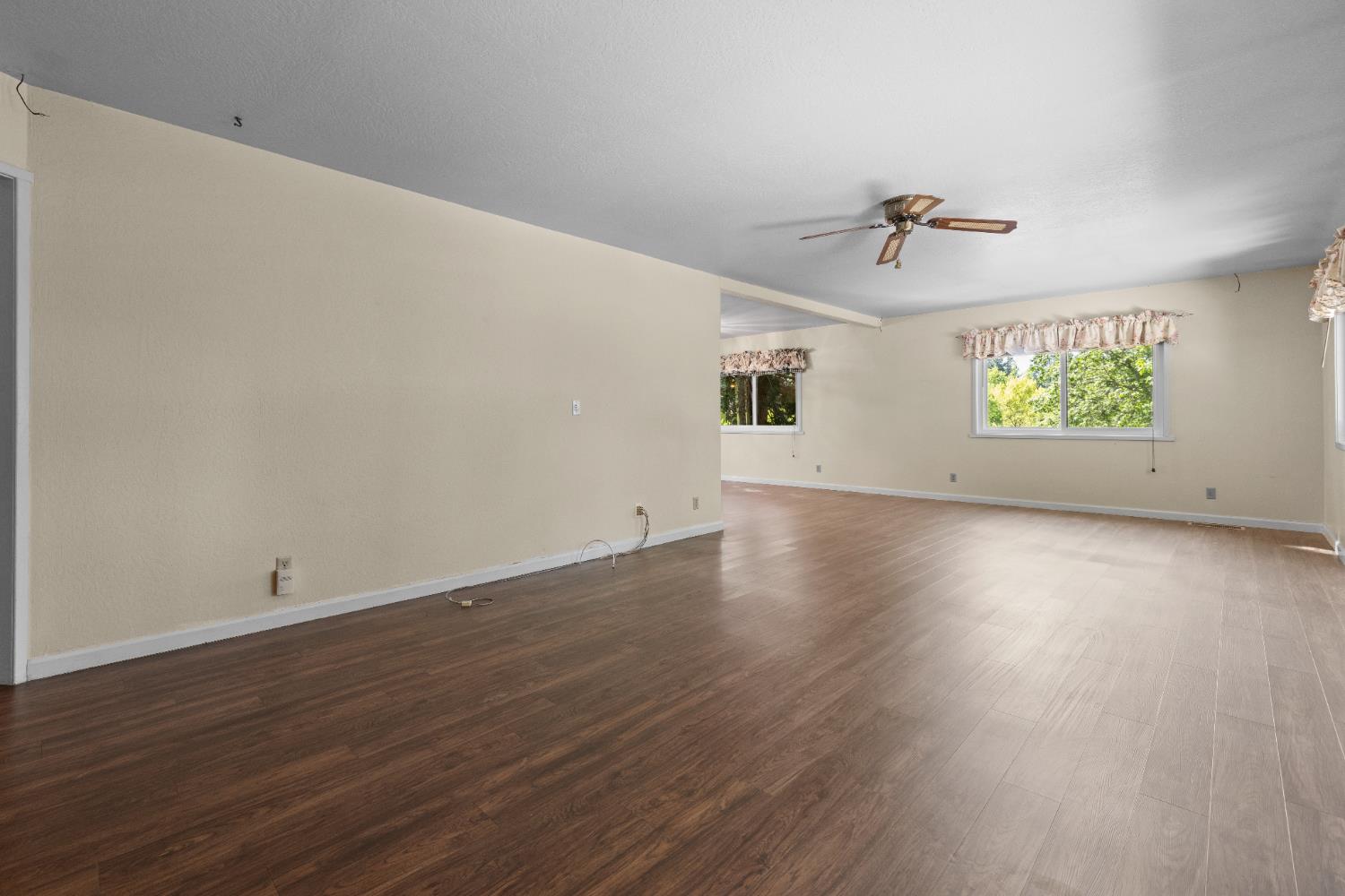 16173 Norlene Way Grass Valley, CA 95949 - Photo 16 of 25 a view of an empty room with wooden floor and a window