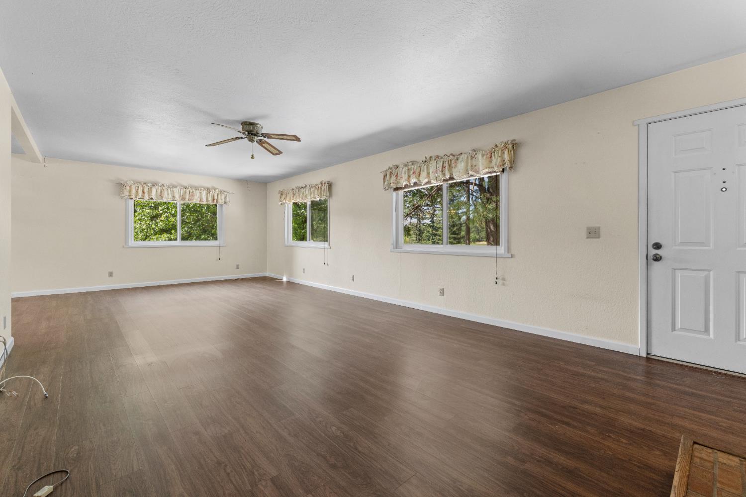 16173 Norlene Way Grass Valley, CA 95949 - Photo 17 of 25 an empty room with wooden floor and windows